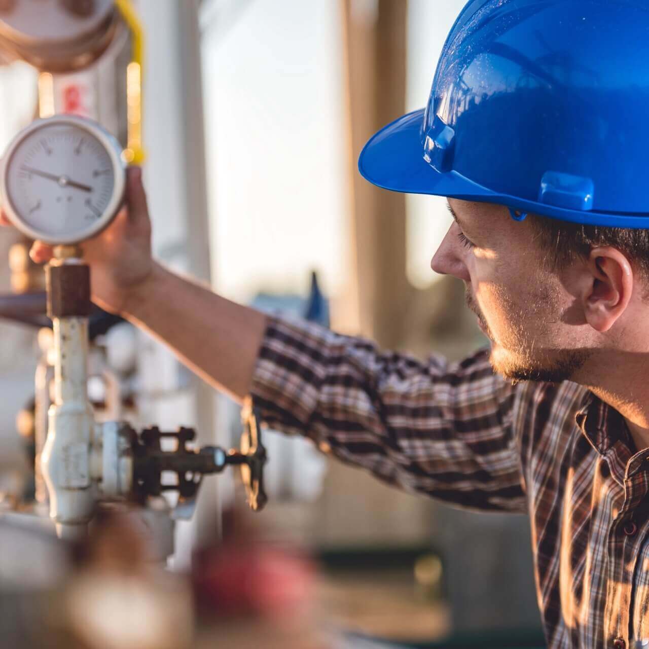 Man checking manometer in natural gas factory